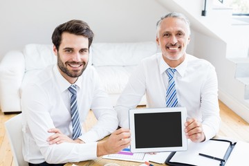 Fototapeta premium Businessmen holding digital tablet in office
