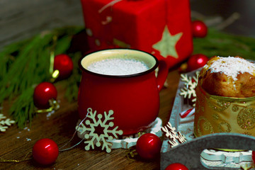 Cristmas panettone with red Christmas balls, Christmas tree on a dark background