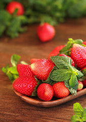 strawberries on a wooden plate on a wooden background