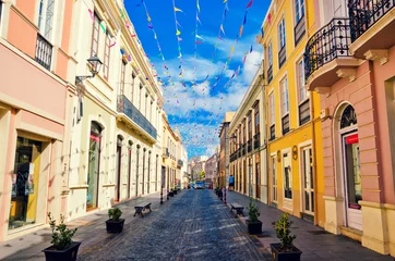 Foto auf Acrylglas City street in La Orotava decorated with colorful flags. Historical center and architecture of La Orotava. Tenerife, Canary islands, Spain. © Betelgejze