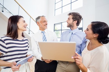 Business people interacting using digital tablet and laptop