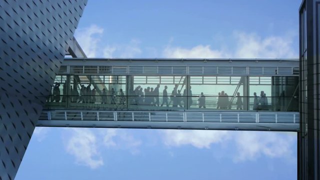 business people inside a modern glass building.