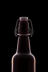 Brown swing top beer bottle on a black background
