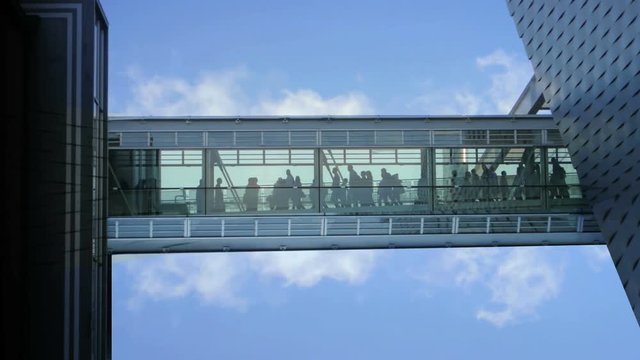 business people inside a modern glass building.
