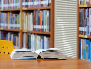 Book open page on wood desk in the library room, education concept