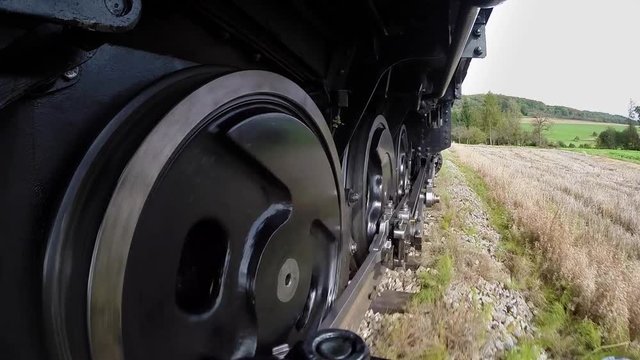 pov view of steam engine train wheels. locomotive background.