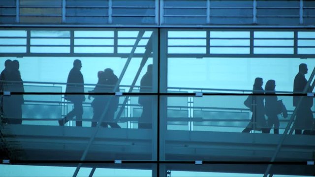 business people inside a modern glass building.