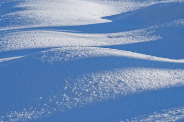  Winter nature background blue and white waves of snow drifts.