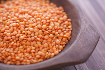 Red lentil in wooden bowl