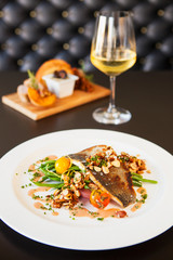 trout amandine with a glass of chardonnay