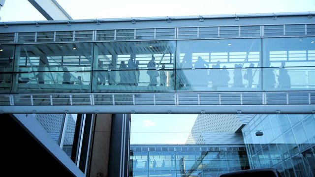 business people inside a modern glass building.