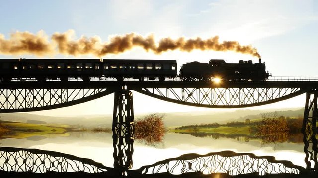 silhouette of steam engine train crossing bridge road at sunset sky. locomotive background.