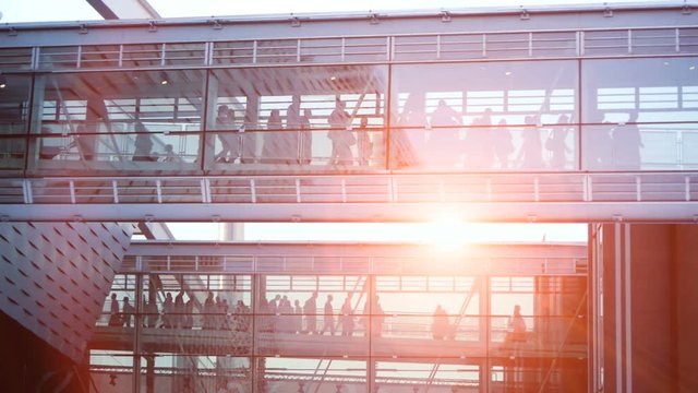 business people inside a modern glass building.