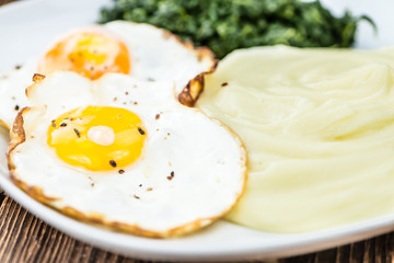 Mashed Potatoes with spinach and fried egga (selective focus)