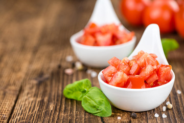 Diced Tomatoes (selective focus) on vintage wooden background
