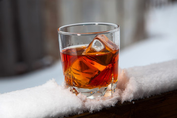 Whiskey with ice on a winter background - 128691529