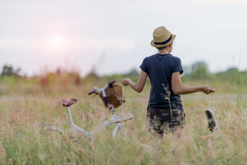 Girl is in the field of meadow looking for picnic area