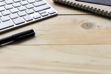 working with computer PC on wood table background. over light, retro tone and high contrast.  [blur and select focus background