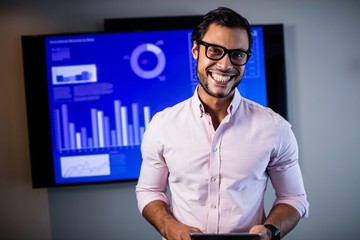 Handsome businessman standing and smiling 