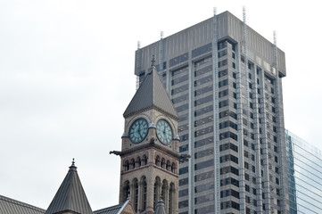 Obraz premium Old city hall clock tower and skyscraper in Toronto downtown