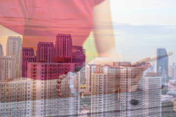 Double Exposure Image of Asian young woman or girl in red shirt use smart phone with building tower or cityscape on the background.