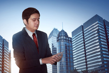 Businessman busy on city background