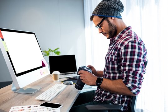 Side view of hipster working at desk