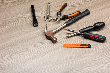 The repair tools is placed on the wooden table.