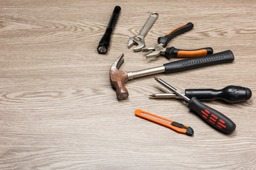The repair tools is placed on the wooden table.