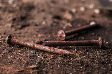 Three Rusty Nails on a Dirty Shop Table