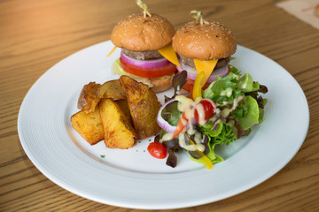 Delicious hamburgers served on wooden planks