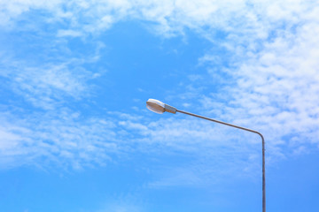 street lamp post with blue sky and cloud.