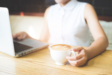 Businesswoman Working On Laptop In Coffee Shop. Young business w