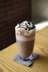 Ice cold coffee on a wooden table