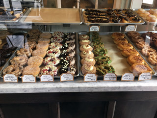 doughnuts and other pastries in a glass display case
