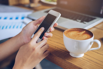 Woman use of smart phone at cafe