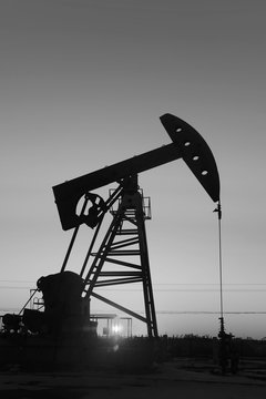 The beam pumping unit is homework, sunset in oil field