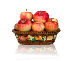 Ripe red apple in wicker basket isolated on white