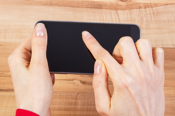 Hand of woman touching blank screen of mobile phone