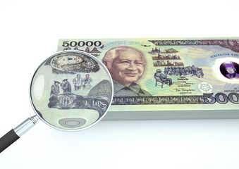 3D Rendered Indonesia money with magnifier investigate currency isolated on white background 