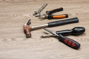 The repair tools is placed on the wooden table.