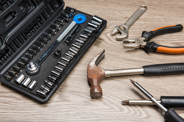 The repair tools is placed on the wooden table.