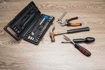 The repair tools is placed on the wooden table.