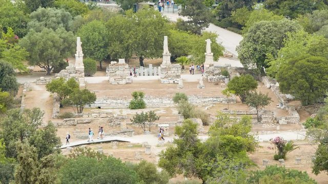 Roman Agora Ruins in Athens Greece with Tourists Exploring the Historical Site viewed from the Acropolis Hill