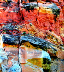 Red rock formation abstract displayed outdoors.