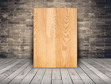 Blank plank wood board at grunge brick wall and wood plank floor