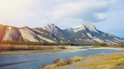 lake and mountain snow on top with sun ray effect background
