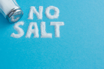 Words no salt written in salt. Lettering. Crumbled salt on a blu