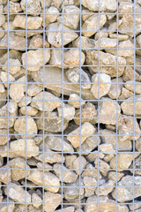 Brown stones for the gray metal grid, background, texture