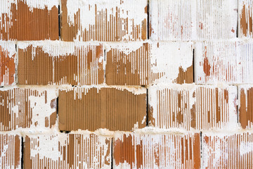 Wall of red brick with white paint, background, texture